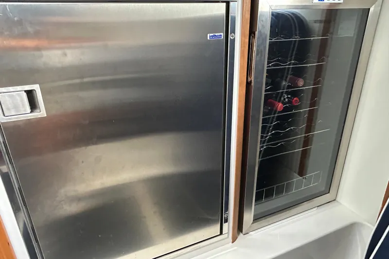  Yacht Photos Pics Stainless steel fridge and wine cooler on 2022 Sabre 45 Salon Express yacht.