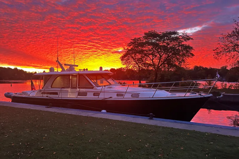  Yacht Photos Pics 2022 Sabre 45 Salon Express yacht docked at sunset with vibrant sky.