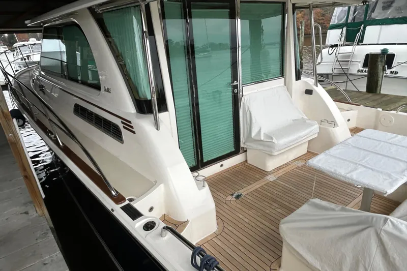  Yacht Photos Pics 2022 Sabre 45 Salon Express yacht with covered seating and sleek design.