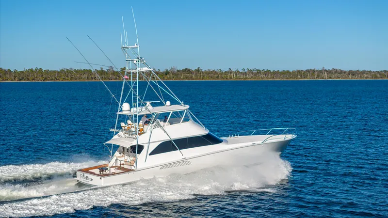 First Bite Yacht Photos Pics Luxury Viking 2005 yacht cruising on blue water, clear sky, 2004 model.
