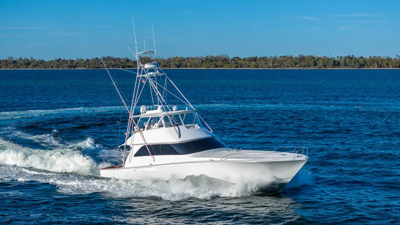 First Bite Yacht Photos Pics A 2004 Viking 2005 model yacht cruising on open water under a clear blue sky.