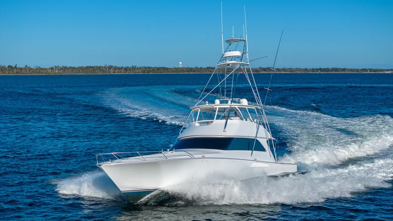 First Bite Yacht Photos Pics Viking 2005 yacht cruising on open water, 2004 model, clear blue sky.
