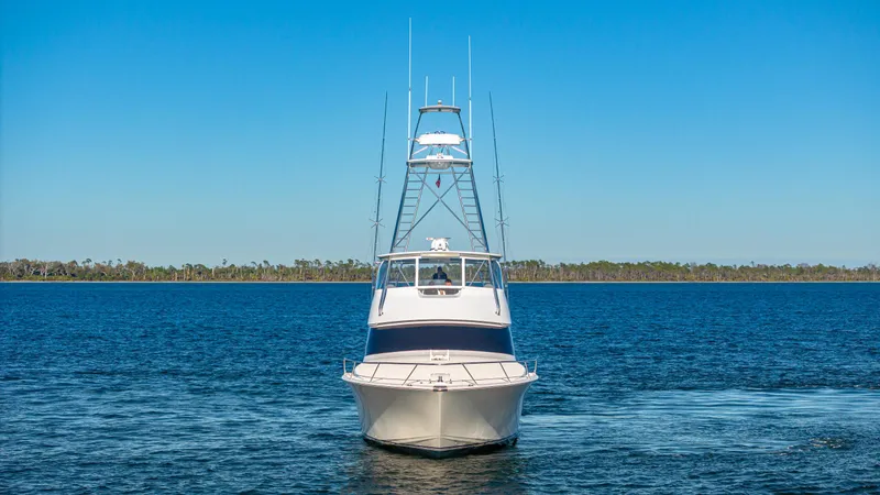 First Bite Yacht Photos Pics Front view of a 2004 Viking 2005 boat on a calm blue lake.