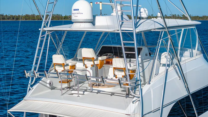 First Bite Yacht Photos Pics Luxury Viking 2005 yacht on blue water, featuring a spacious deck and seating area.