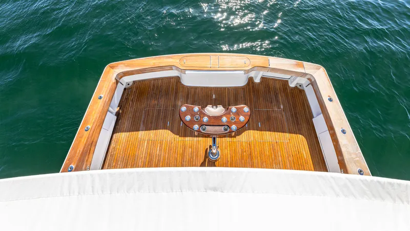 First Bite Yacht Photos Pics Sleek Viking 2005 yacht deck, 2004 model, with polished wood finish on open water.