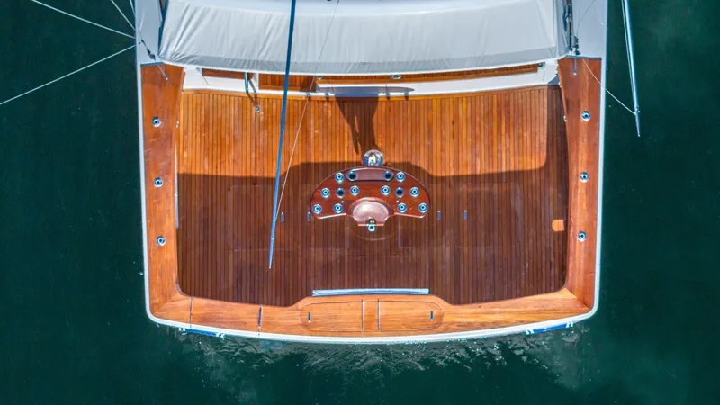 First Bite Yacht Photos Pics Overhead view of a 2004 Viking 2005 yacht's wooden deck on water.