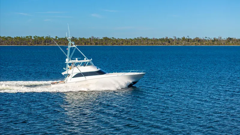 First Bite Yacht Photos Pics Viking 2005 model boat cruising on a serene blue lake, clear sky above.