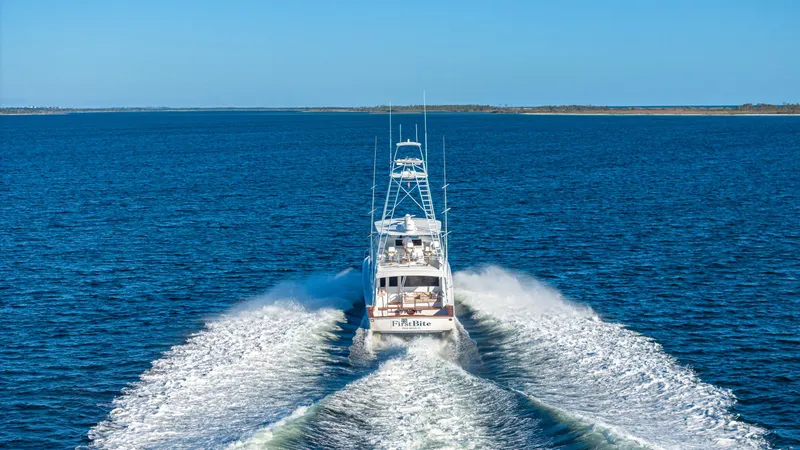 First Bite Yacht Photos Pics Viking 2005 yacht cruising on open water, leaving a wake behind.