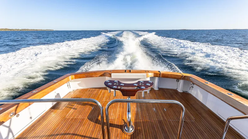 First Bite Yacht Photos Pics Luxury Viking 2005 boat cruising on open water, leaving a wake behind.