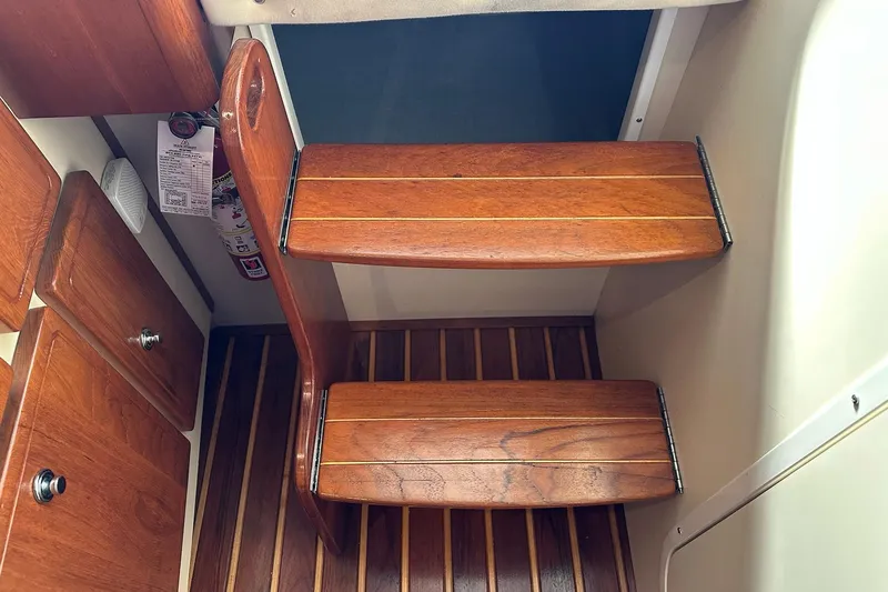  Yacht Photos Pics Wooden interior steps of a 2006 Pursuit 3070 Offshore boat.