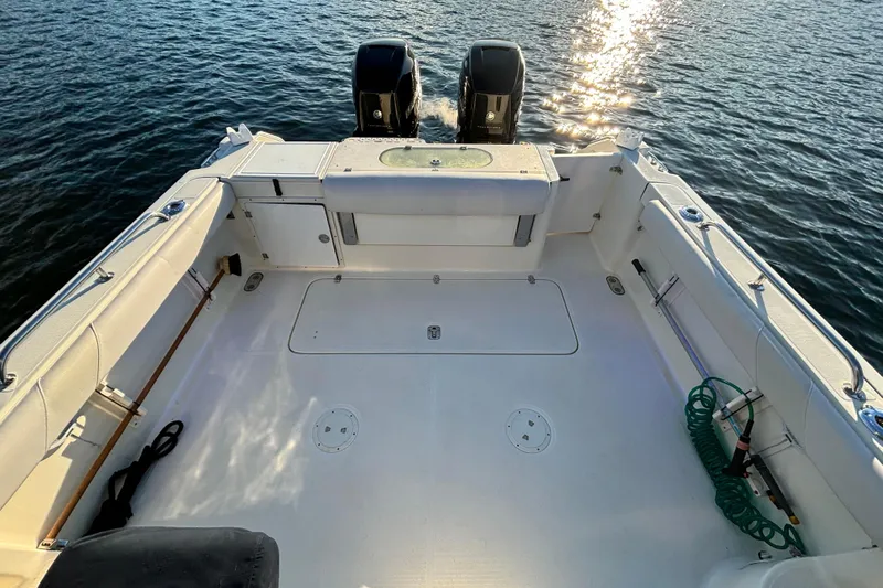  Yacht Photos Pics 2006 Pursuit 3070 Offshore boat deck with twin engines on water.