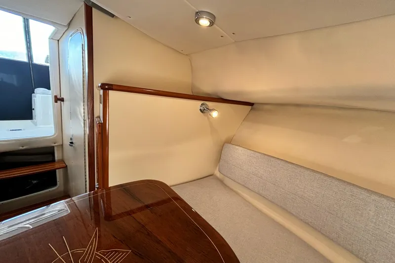  Yacht Photos Pics Interior of 2006 Pursuit 3070 Offshore boat, featuring cozy seating and elegant wood finishes.