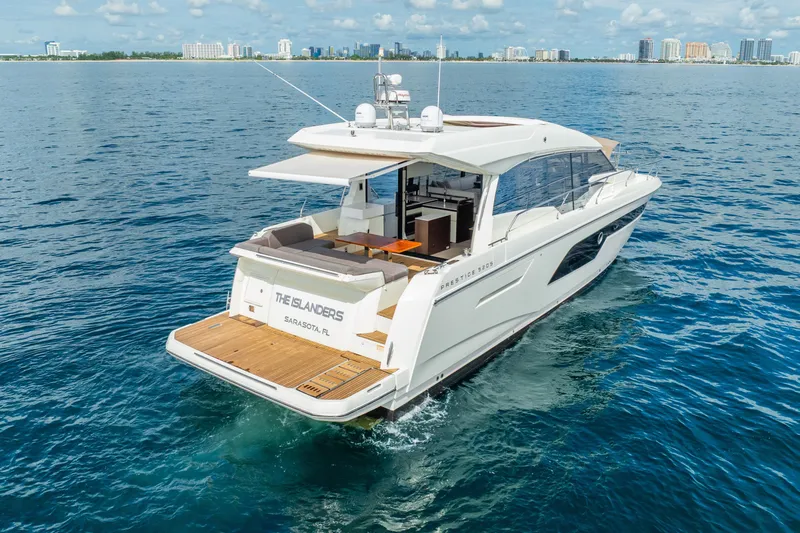  Yacht Photos Pics Luxury 2018 Prestige 520S yacht cruising near Sarasota, Florida, with city skyline in background.