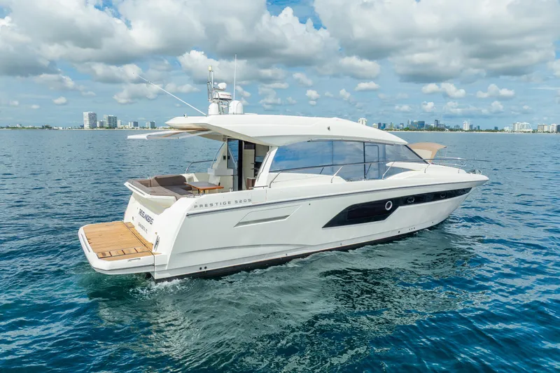  Yacht Photos Pics 2018 Prestige 520S yacht cruising on open water under a partly cloudy sky.