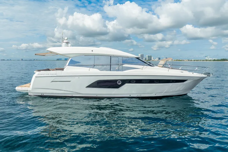  Yacht Photos Pics 2018 Prestige 520S yacht cruising on calm blue waters under a partly cloudy sky.