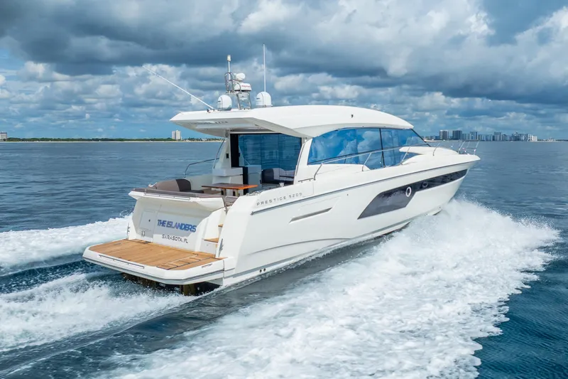  Yacht Photos Pics 2018 Prestige 520S yacht cruising on open water under cloudy skies.