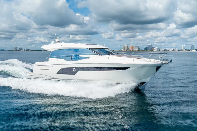  Yacht Photos Pics Luxurious 2018 Prestige 520S yacht cruising on open water under a cloudy sky.