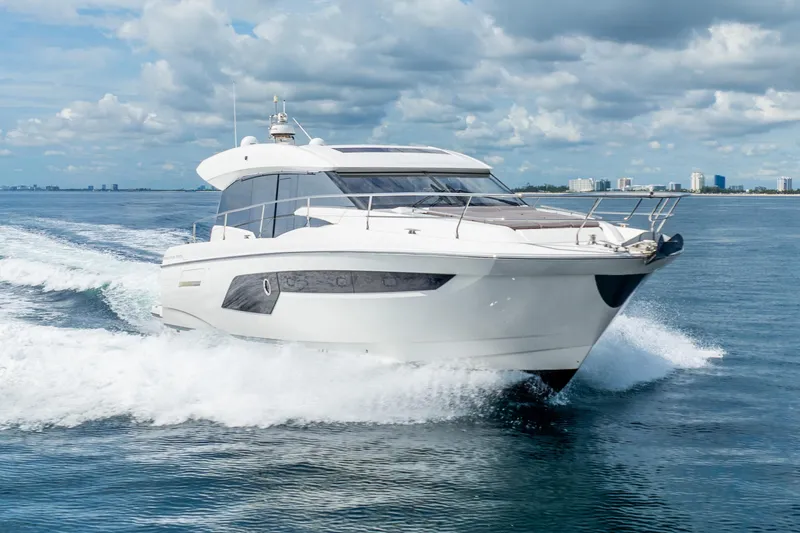  Yacht Photos Pics 2018 Prestige 520S yacht cruising on open water under a partly cloudy sky.