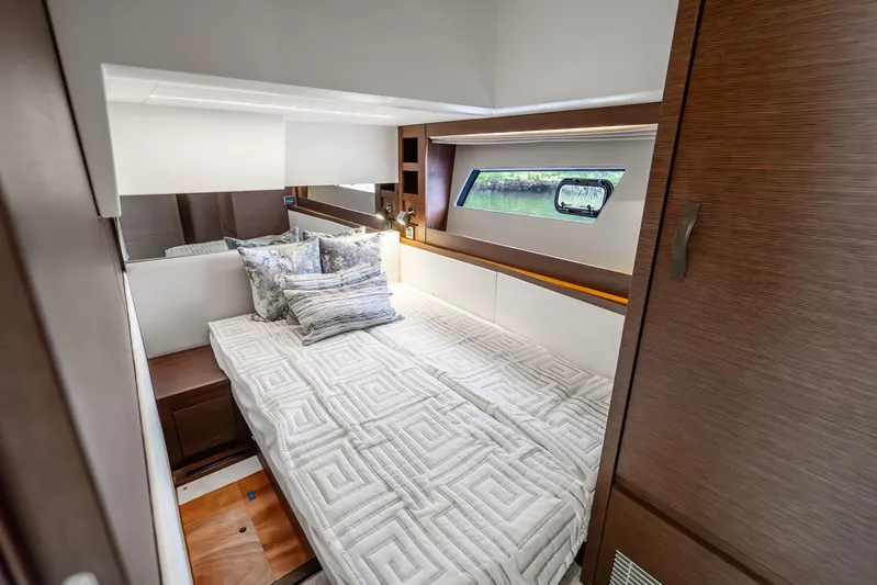 Yacht Photos Pics Luxurious cabin interior of 2018 Prestige 520S yacht with elegant bedding and wood accents.