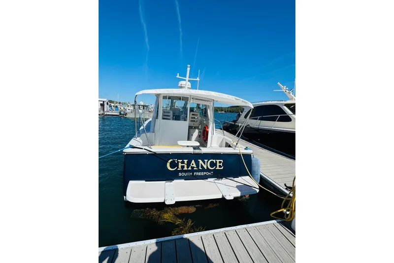 Chance Yacht Photos Pics 2007 Back Cove 29 boat named "Chance" docked at marina, clear blue sky.