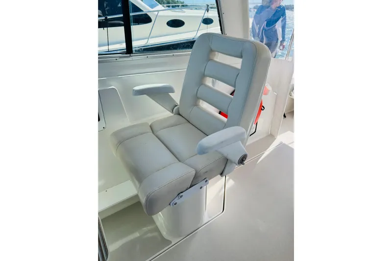 Chance Yacht Photos Pics Captain's chair on a 2007 Back Cove 29 boat, featuring cushioned armrests and sleek design.