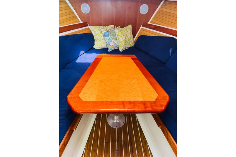 Chance Yacht Photos Pics 2007 Back Cove 29 interior with wooden table, blue seating, and decorative pillows.