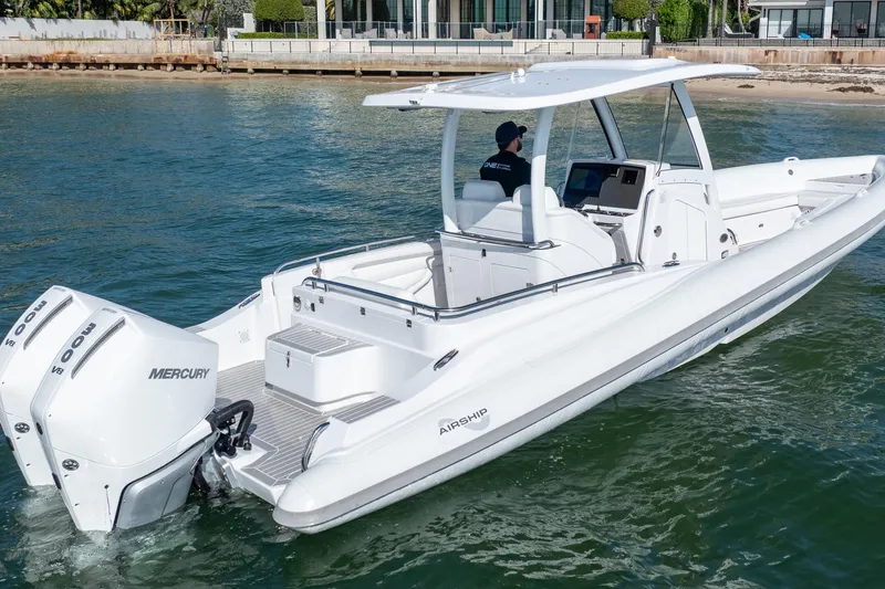  Yacht Photos Pics 2025 Airship 340 boat with dual Mercury engines cruising on water.