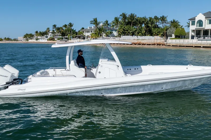  Yacht Photos Pics 2025 Airship 340 boat cruising near a coastal residential area.