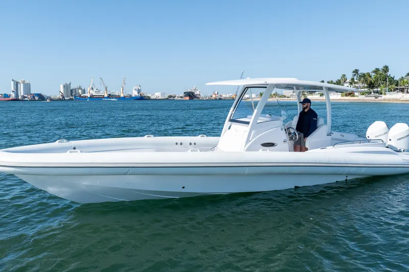  Yacht Photos Pics 2025 Airship 340 boat on water with cityscape background.