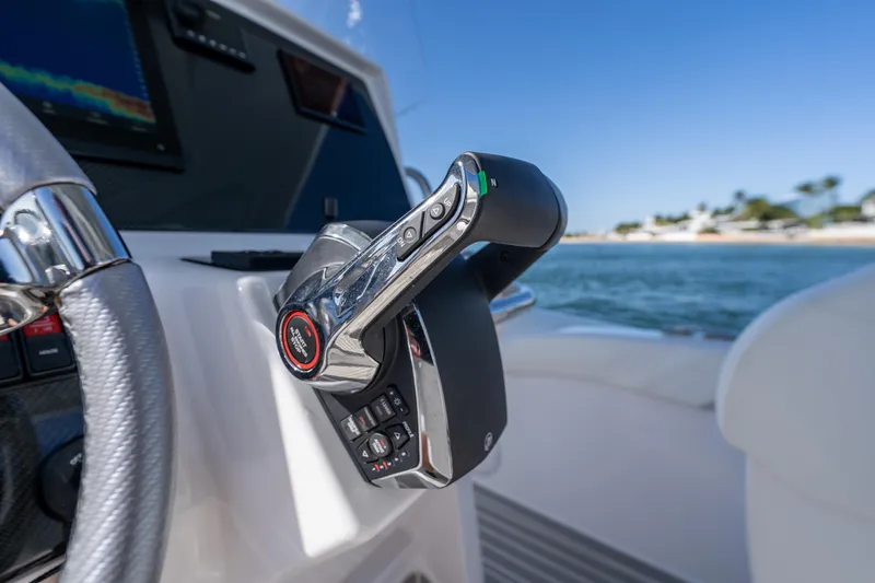  Yacht Photos Pics Close-up of Airship 340 boat controls, 2025 model, with ocean view in background.