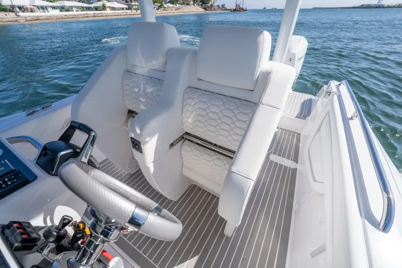  Yacht Photos Pics Luxurious white seating on 2025 Airship 340 boat, featuring modern design and ocean backdrop.