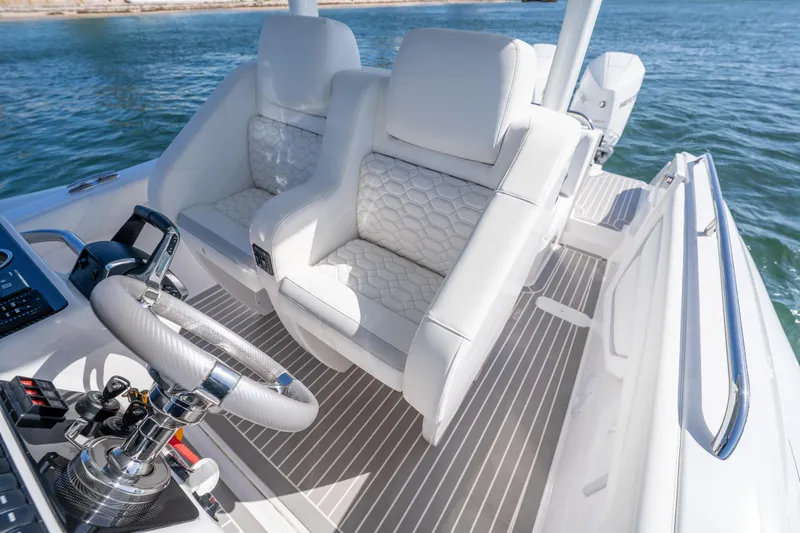  Yacht Photos Pics Luxurious Airship 340 boat interior with white leather seats, 2025 model, on open water.