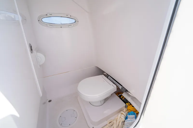  Yacht Photos Pics Compact bathroom in 2025 Airship 340 model, featuring a toilet and porthole window.