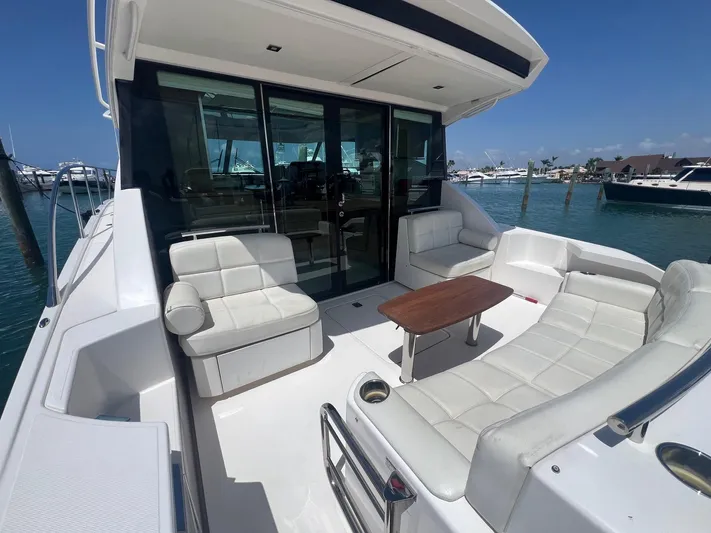 B.u.b. Yacht Photos Pics 2016 Tiara Yachts 44 Coupe, spacious deck with white seating and wooden table.
