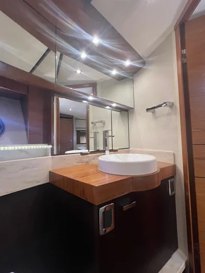 B.u.b. Yacht Photos Pics Luxurious bathroom in 2016 Tiara Yachts 44 Coupe with modern fixtures and wooden accents.