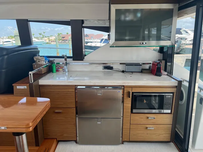 B.u.b. Yacht Photos Pics Modern kitchen area on a 2016 Tiara Yachts 44 Coupe, featuring stainless steel appliances.