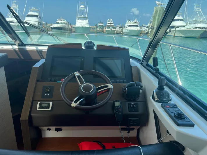 B.u.b. Yacht Photos Pics Helm of 2016 Tiara Yachts 44 Coupe with marina view.