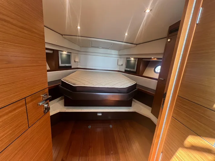 B.u.b. Yacht Photos Pics 2016 Tiara Yachts 44 Coupe bedroom with luxurious wood finish and modern lighting.