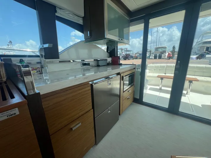 B.u.b. Yacht Photos Pics Modern kitchen area on a 2016 Tiara Yachts 44 Coupe with outdoor view.