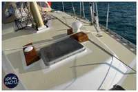 Deck of 1976 BOUVIER/JOUFFRAY BILINGA yacht with ropes and hatch, on calm water.