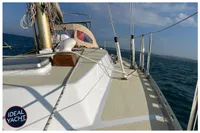 Sailing yacht BOUVIER/JOUFFRAY BILINGA 1976 on open sea, deck view with clear skies.