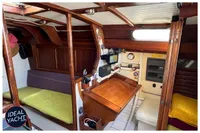 Interior of 1976 BOUVIER/JOUFFRAY BILINGA yacht with wooden furnishings and navigation equipment.
