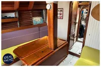 Interior of 1976 BOUVIER/JOUFFRAY BILINGA yacht with wooden furnishings and cozy seating.