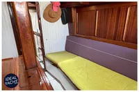 Interior of 1976 BOUVIER/JOUFFRAY BILINGA yacht with wooden finish and cozy seating.
