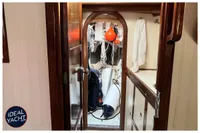 Interior view of 1976 BOUVIER/JOUFFRAY BILINGA yacht with wooden door and nautical equipment.