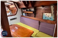 Interior of 1976 BOUVIER/JOUFFRAY BILINGA yacht with wooden furnishings and cozy seating area.