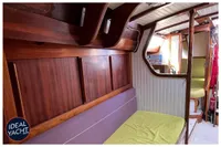 Interior of 1976 BOUVIER/JOUFFRAY BILINGA yacht with wooden paneling and seating.
