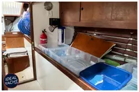 Interior of 1976 BOUVIER/JOUFFRAY BILINGA yacht with storage and fire extinguisher.