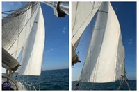 Sailing yacht BOUVIER/JOUFFRAY BILINGA 1976 with white sails against blue sky and ocean.