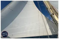 Sailing yacht BOUVIER/JOUFFRAY BILINGA 1976 with white sails against blue sky.